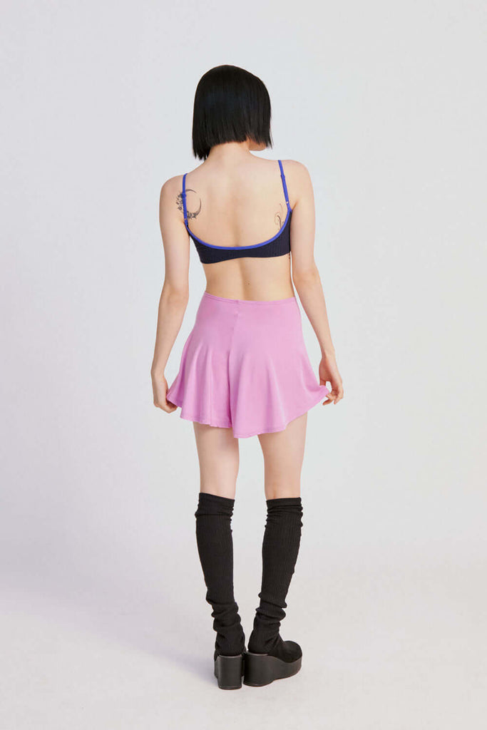 model in back view wearing TENCEL™ skort (B-GRADE) orchid color